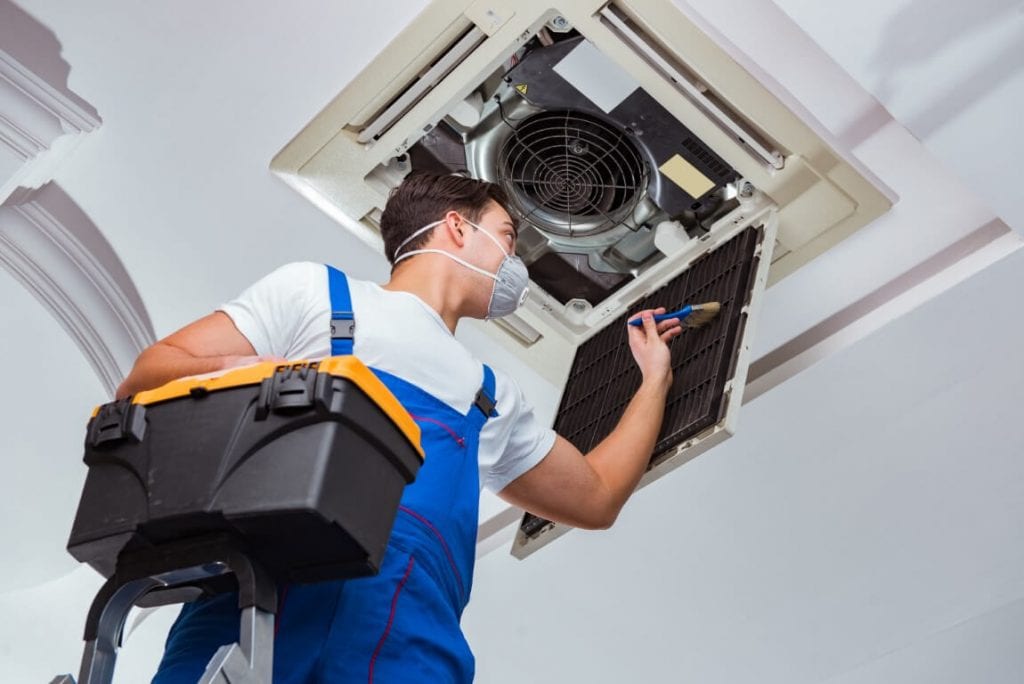 hvac technician cleaning vents